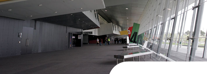 Champion XP berber carpet tile installed in a conference center or arena entrance foyer